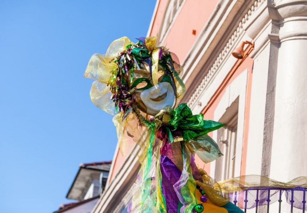 a large Mardi Gras mask on the street
